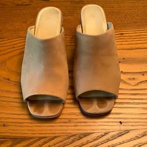 Nisolo Paloma open toe mules in sand.